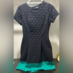 Short sleeve navy dress with green band on bottom. Bubble style design